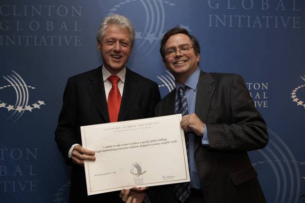 Former President Bill Clinton and Jim Fruchterman celebrate Benetech's commmitment to international Bookshare.org at the Clinton Global Initiative 2006.